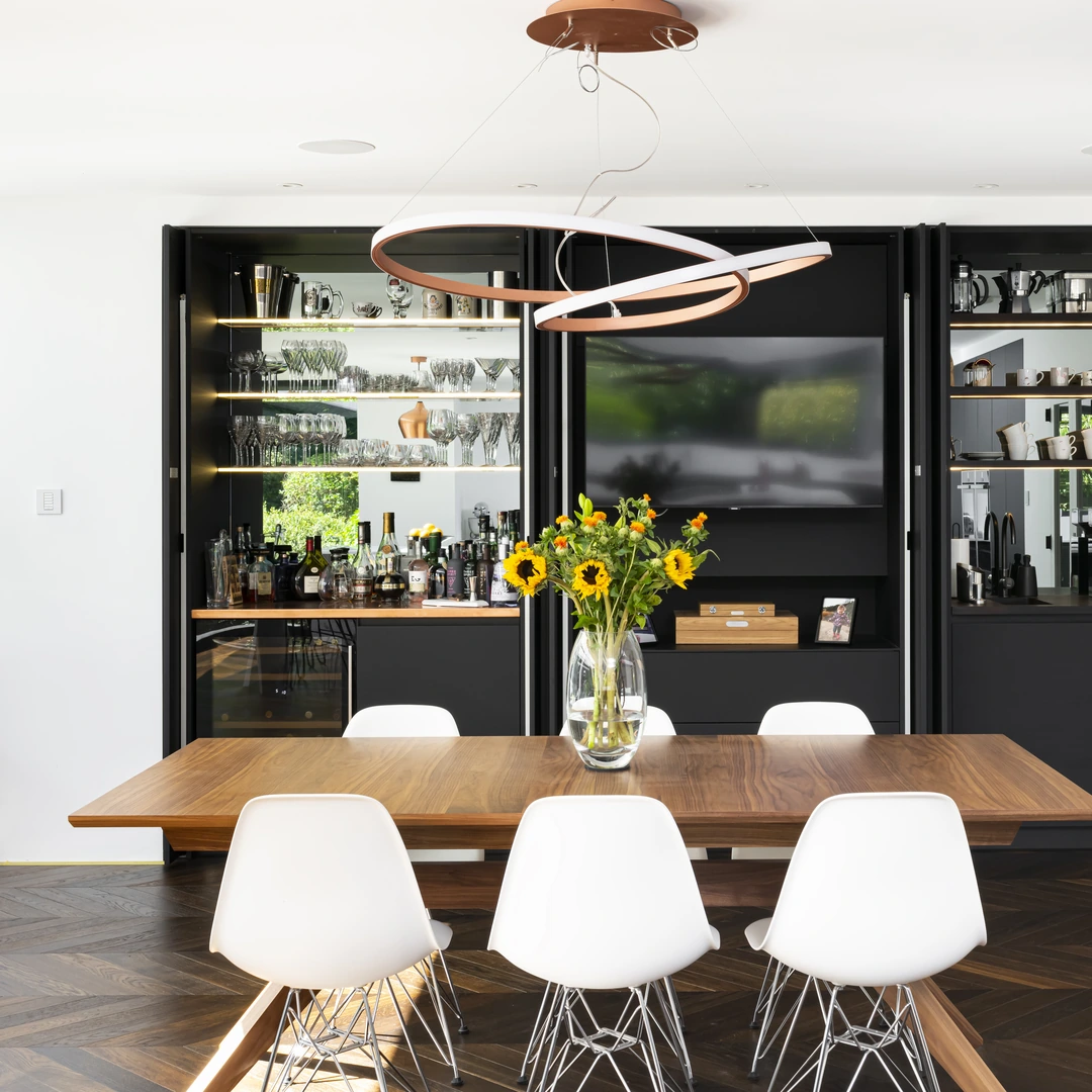 Schmidt fitted kitchen with a black pocket-door bar and coffee station